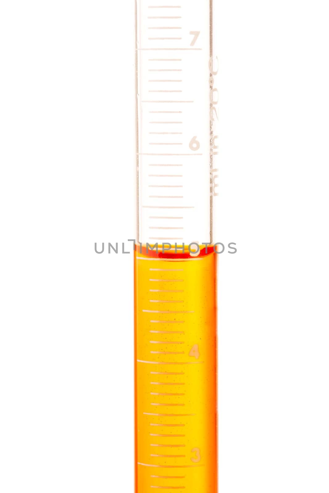 Measuring 5 ml of orange liquid in glass pipette