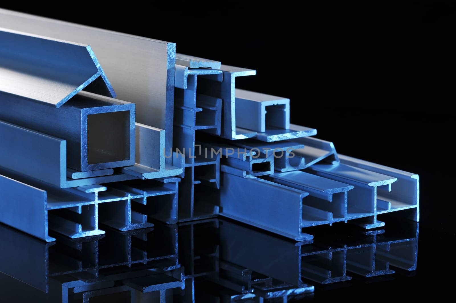 many different aluminium profile strips in blue spotlight