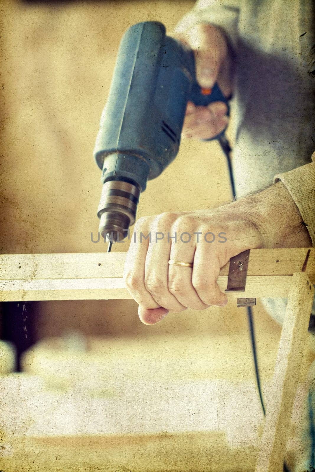 Man's arms drill lath in the workshop - vintage photo