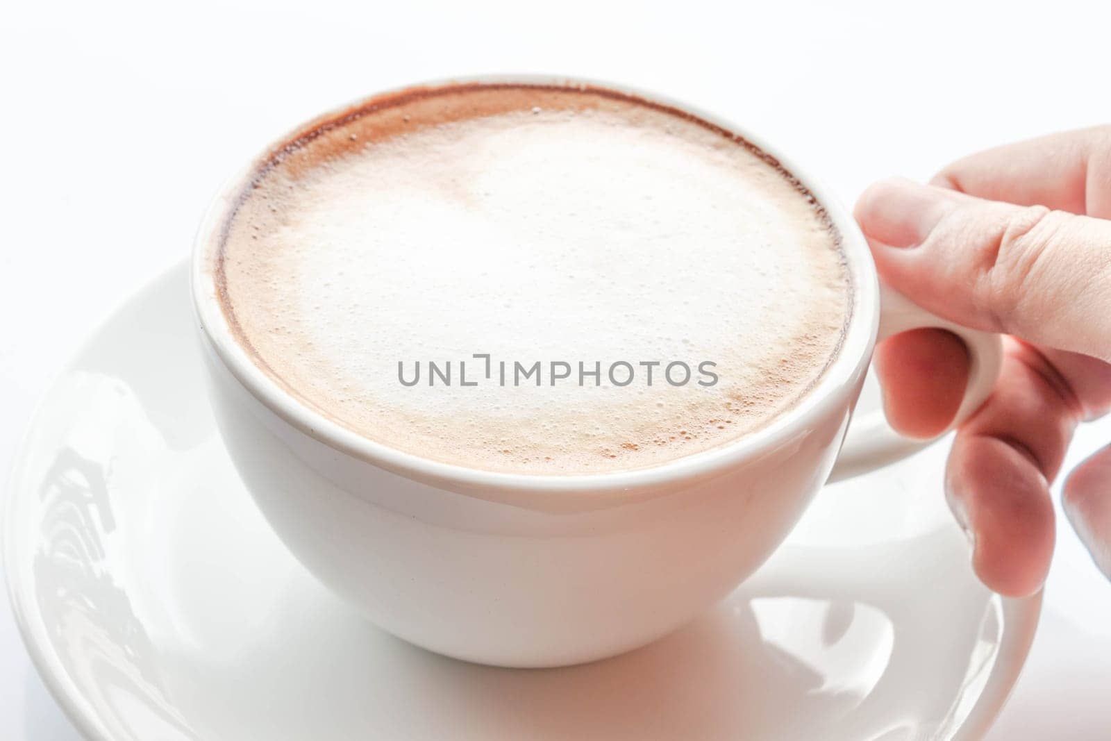 Hand on cup of hot coffee latte