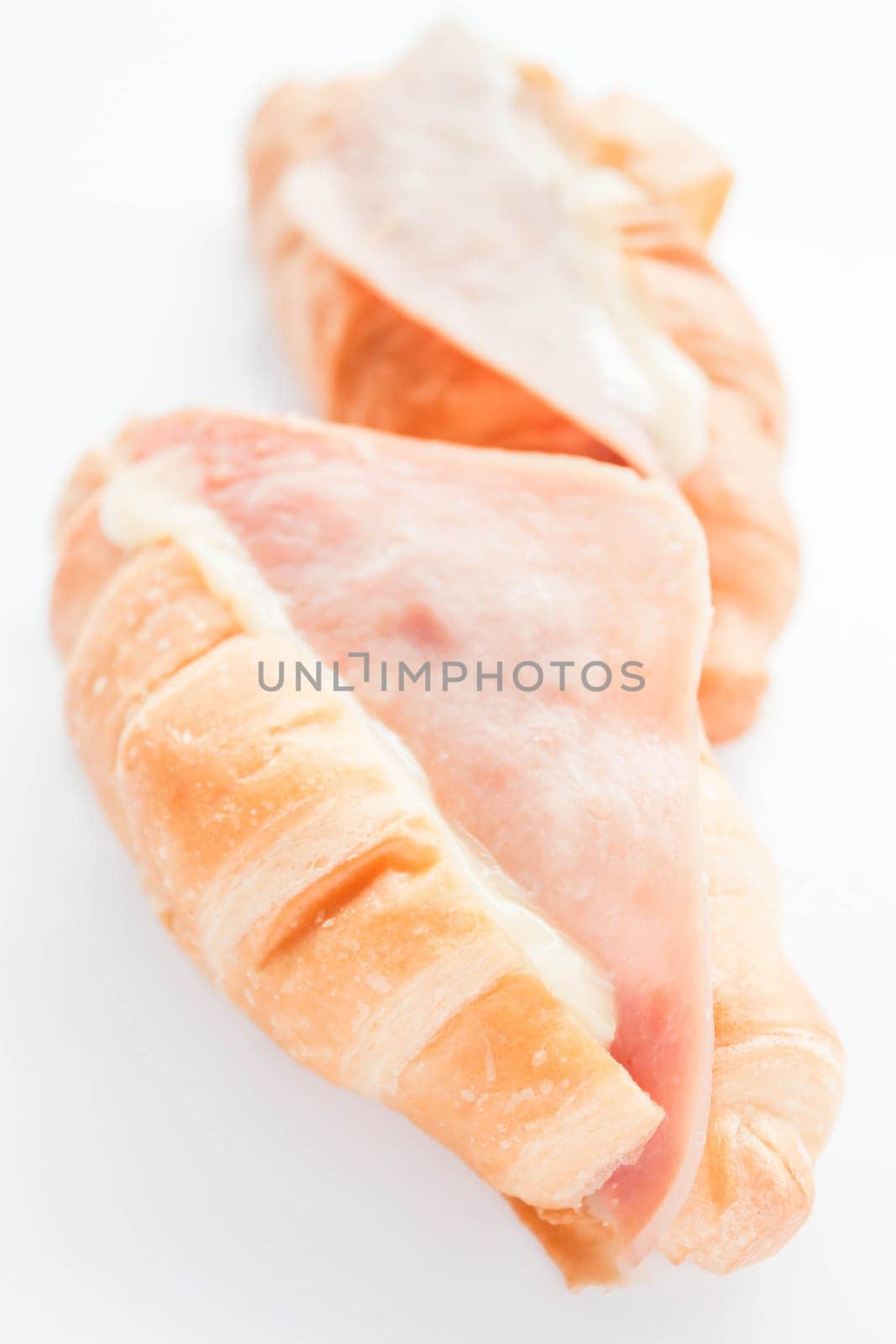 Delicious croissants with ham cheese isolated on white background