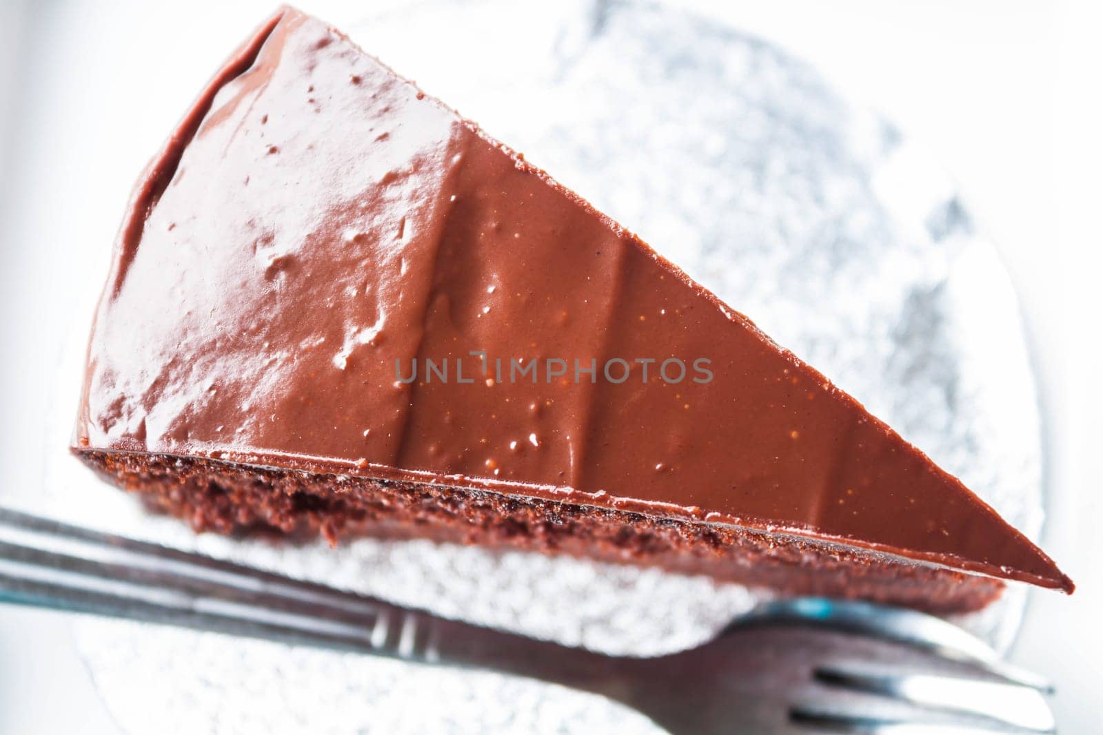 Top view of chocolate cake with spoon and fork