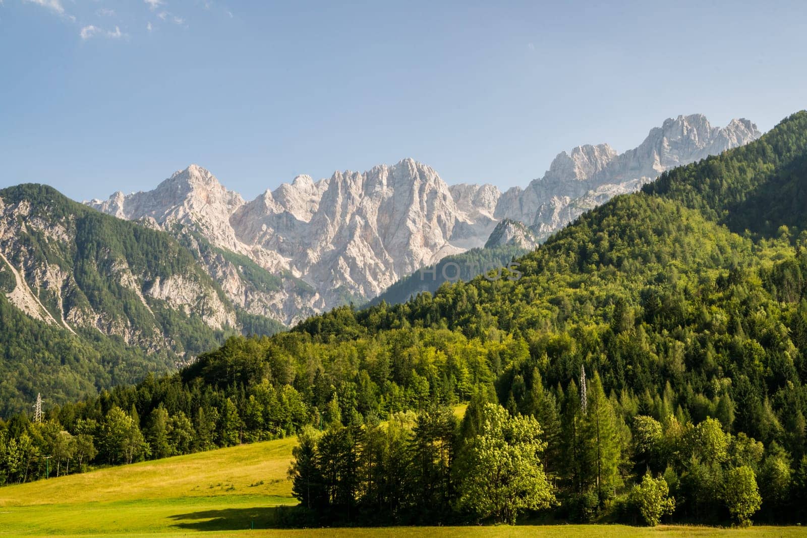 View to the Julian Alps inclduing Mt. Triglav, the highest mountain and national symbol of Slovenia, from the Kranjska Gora region. The mountains of the Julian Alps form an impressive wall in that view.