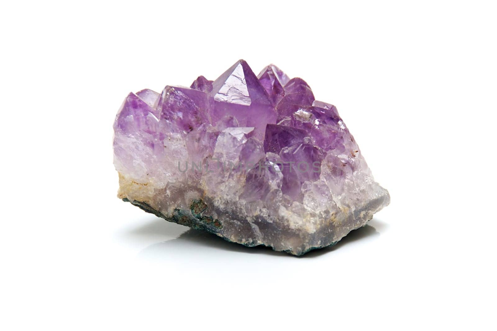 Close up of purple amethyst cluster with many points, shot on white background
