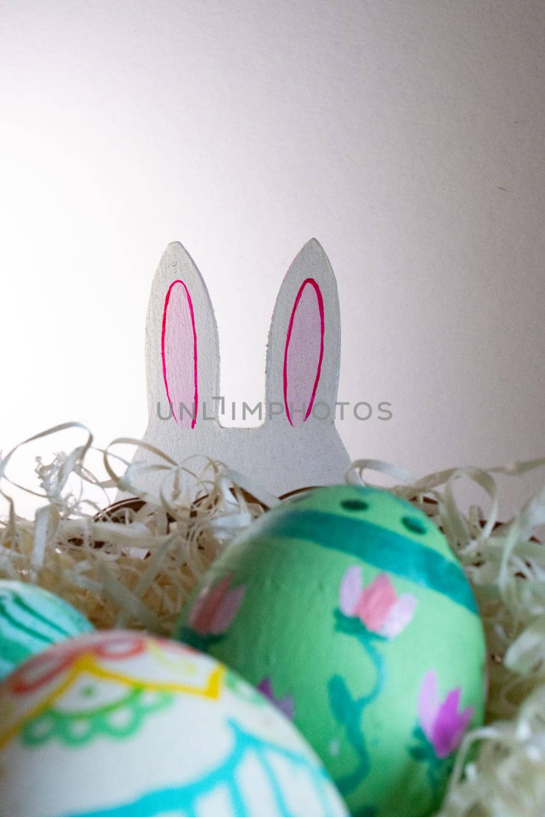 Easter eggs , flowers and funny bunny to celebrate Easter. space for copy.Wallpaper for Easter announcements and cards.Vertical real picture, ideal for social media stories and postings