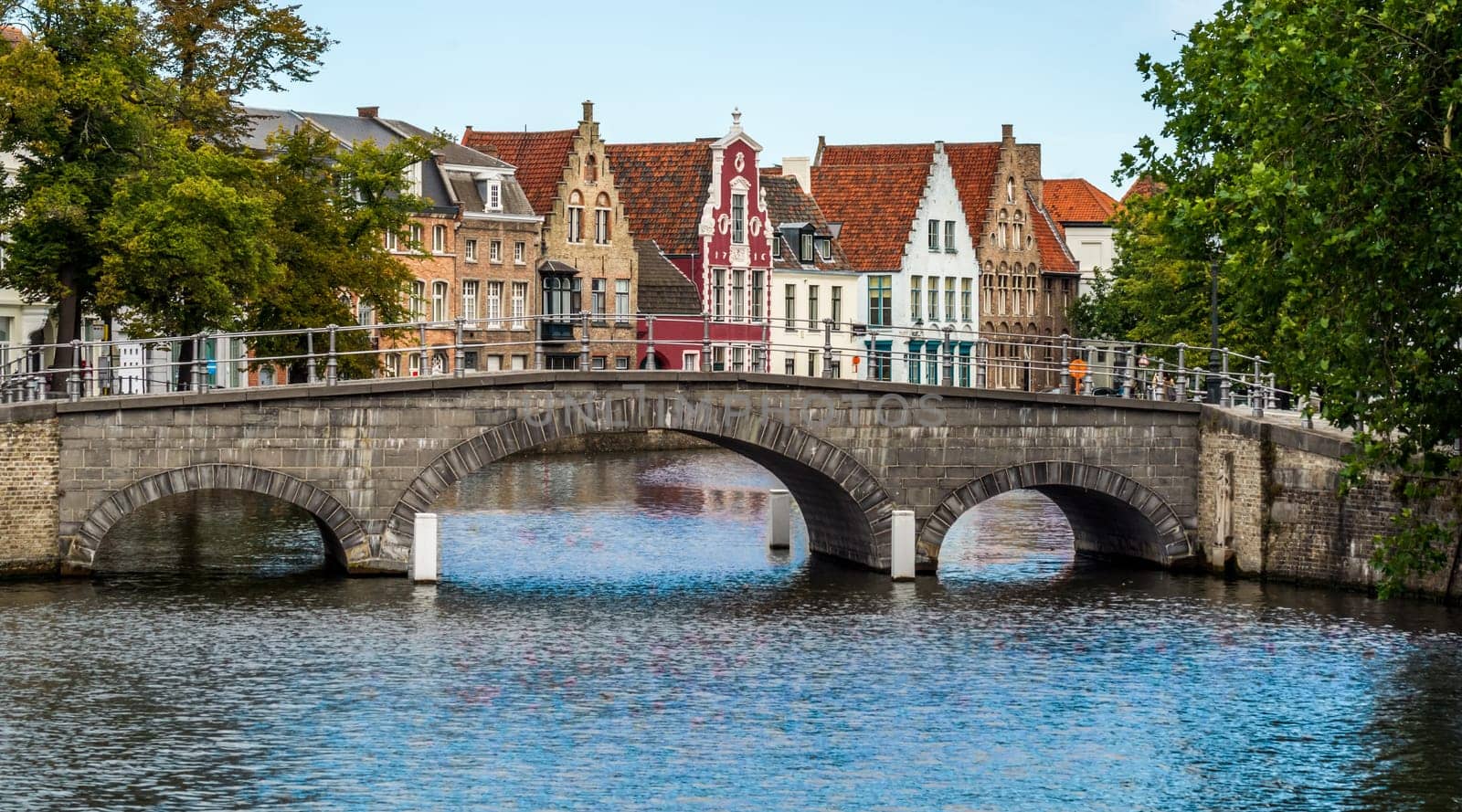 Picturesque view across a bridge to historic brickwall town houses in the famous belgian city of Brugge.