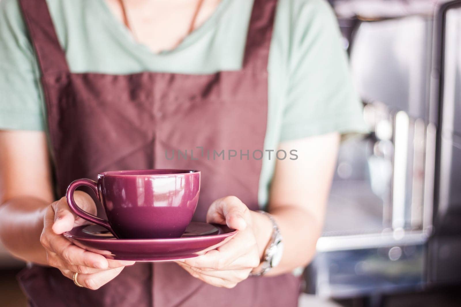 Shop owner serving freshly brewed coffee, stock photo