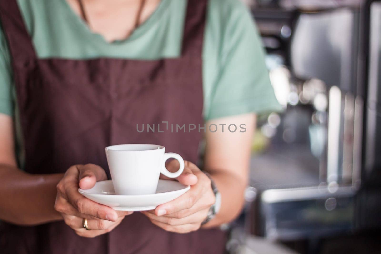 Asian barista serving freshly brewed coffee, stock photo