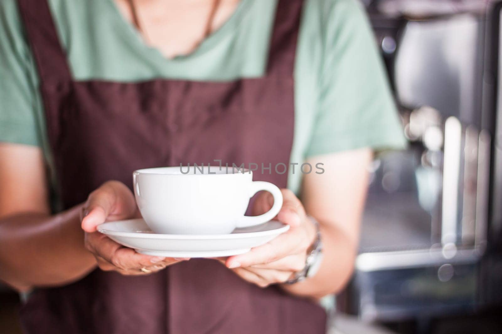 Barista serving freshly brewed coffee, stock photo
