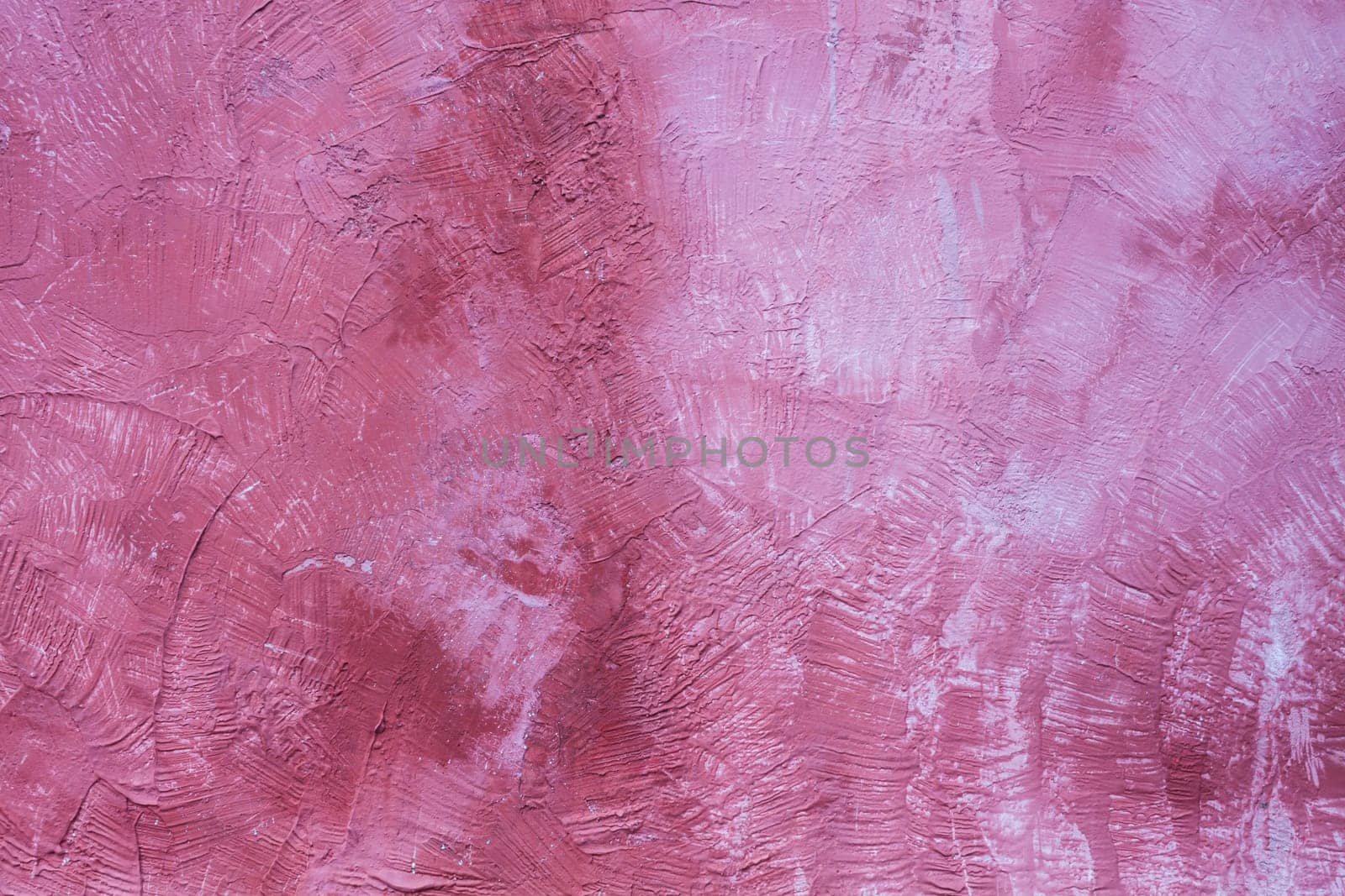Handmade pink wall with stains and scratches