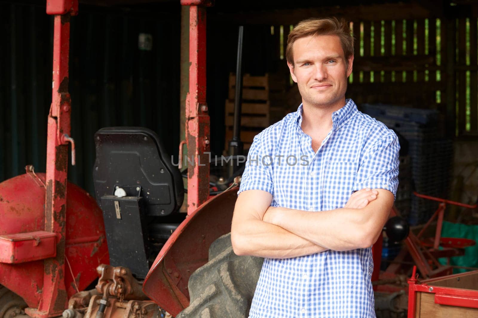 Portrait Of Farmer With Old Fashioned Tractor