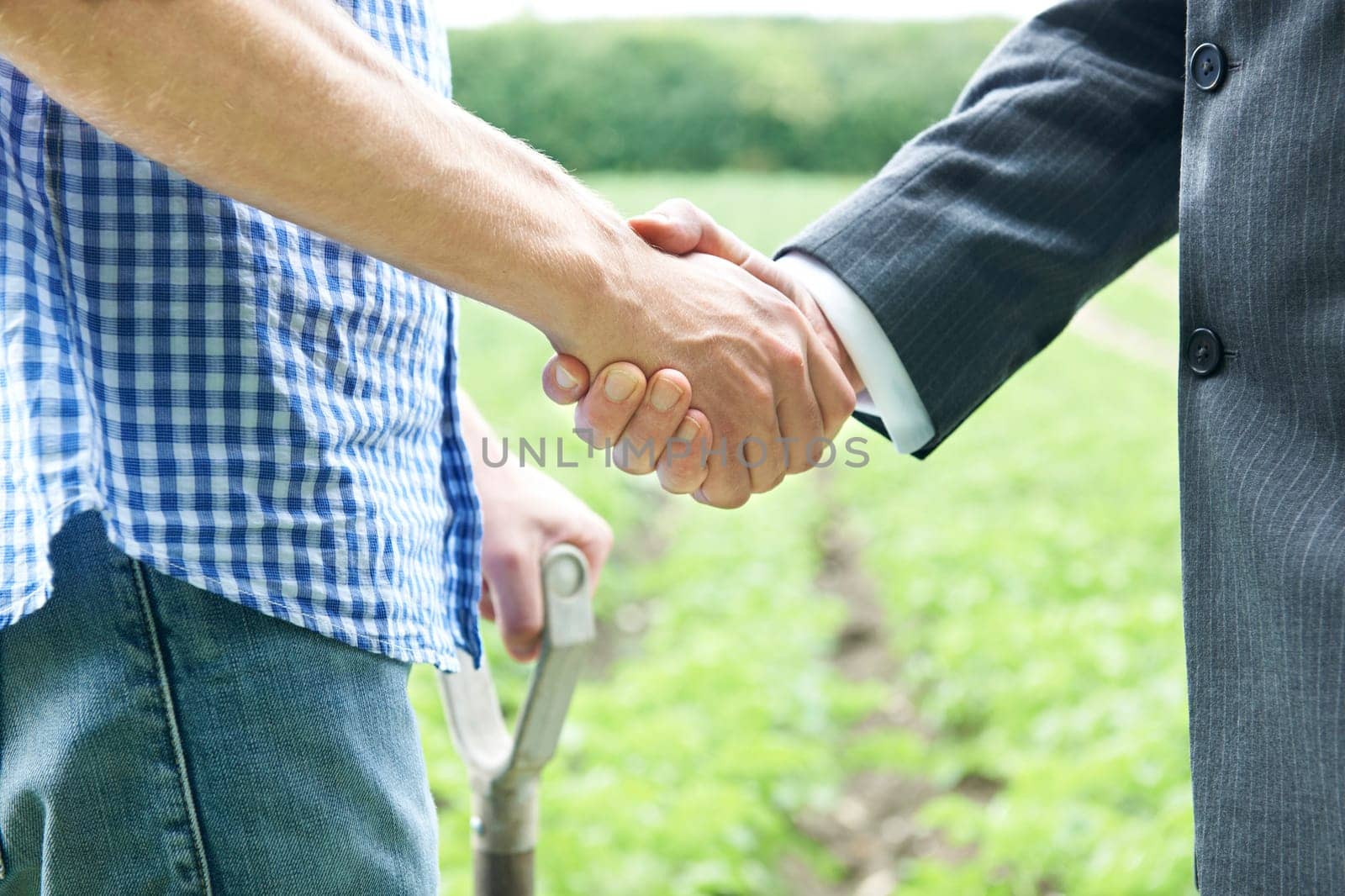 Farmer And Businessman Shaking Hands