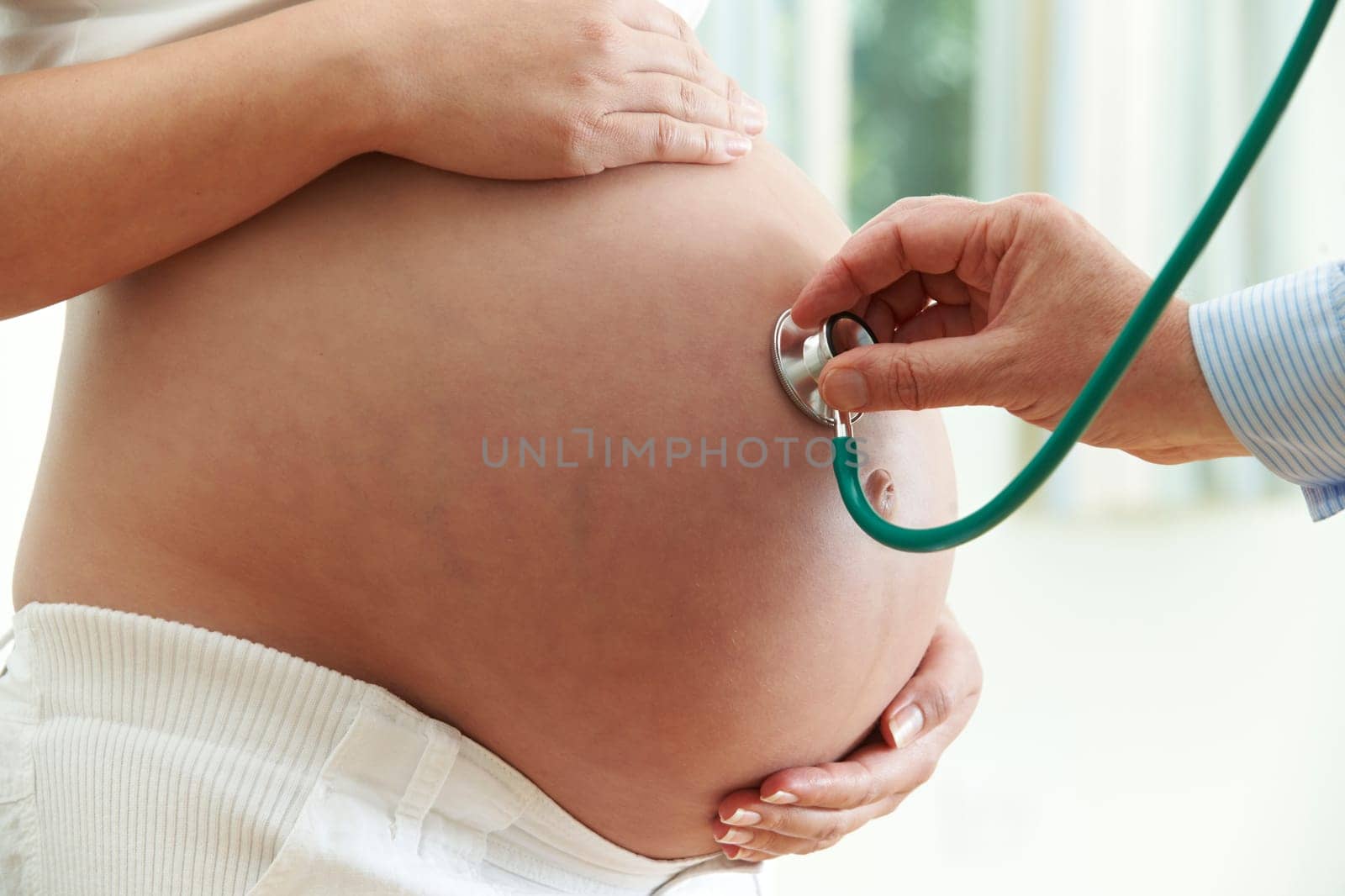 Doctor Giving Healthcheck To Pregnant Woman
