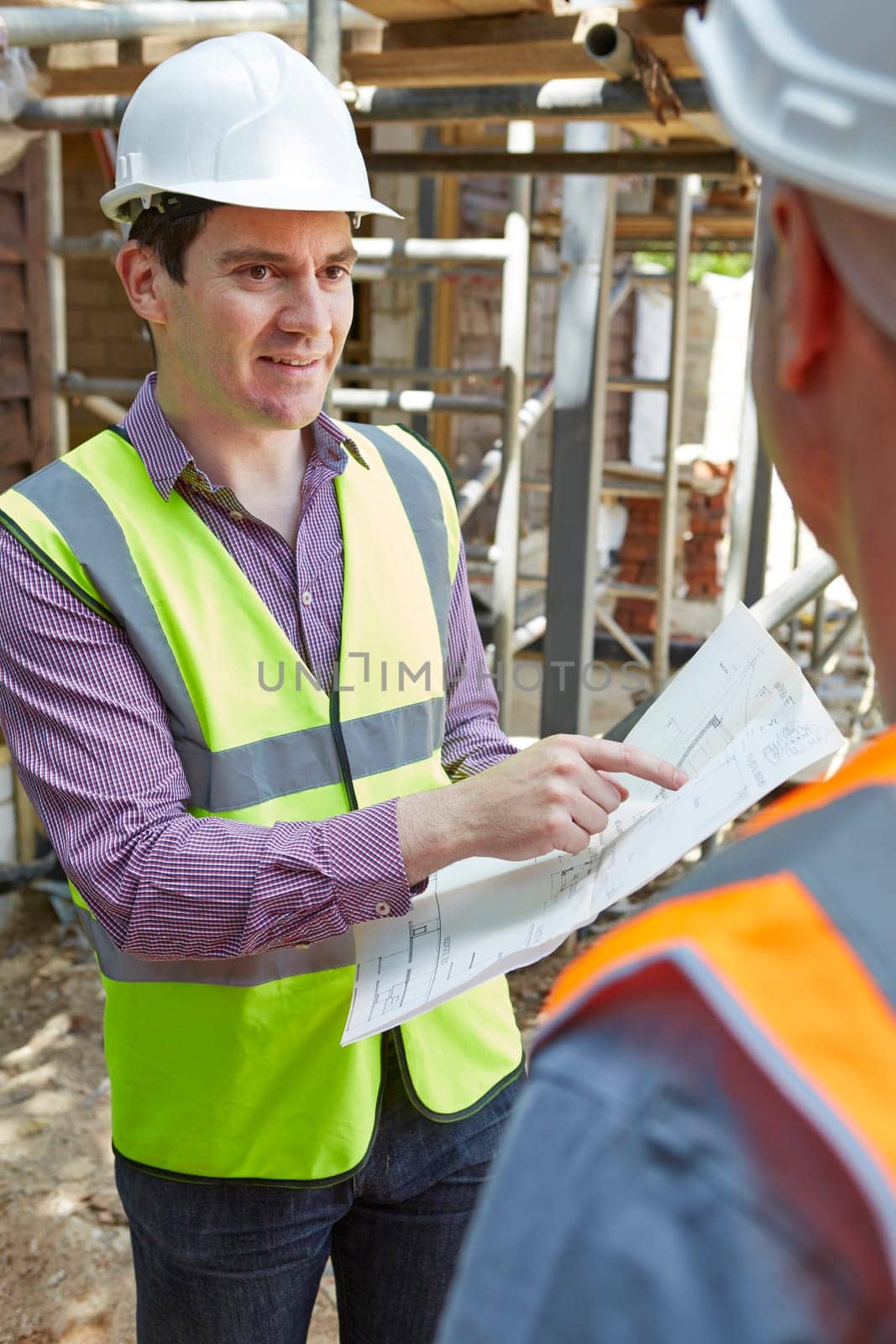 Architect Discussing Plans With Builder
