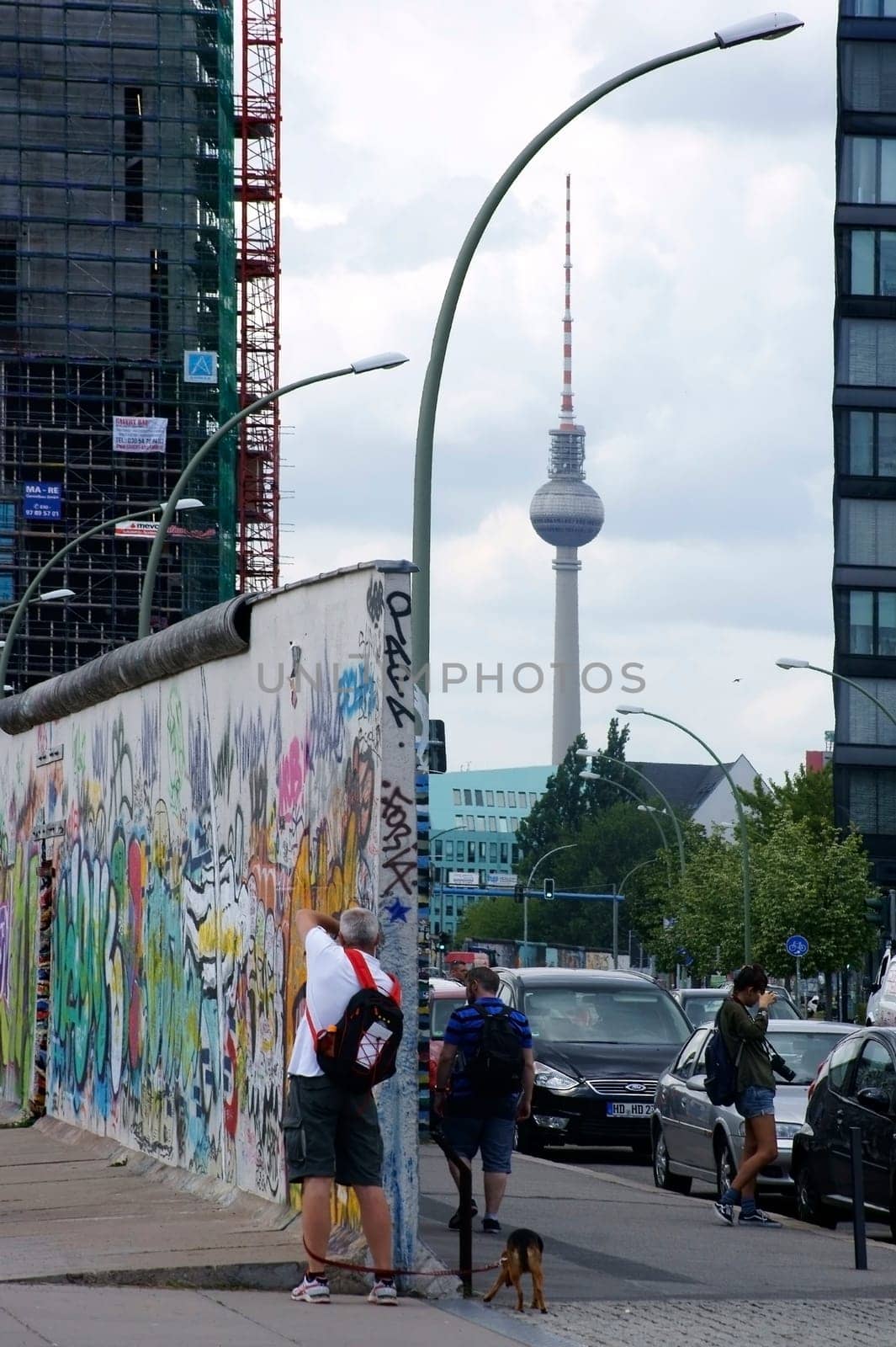 Berlin,Germany -June 16,2014: Tourists photograph a piece of the Berlin Wall at the East Side Gallery on June 16,2014 in Berlin.