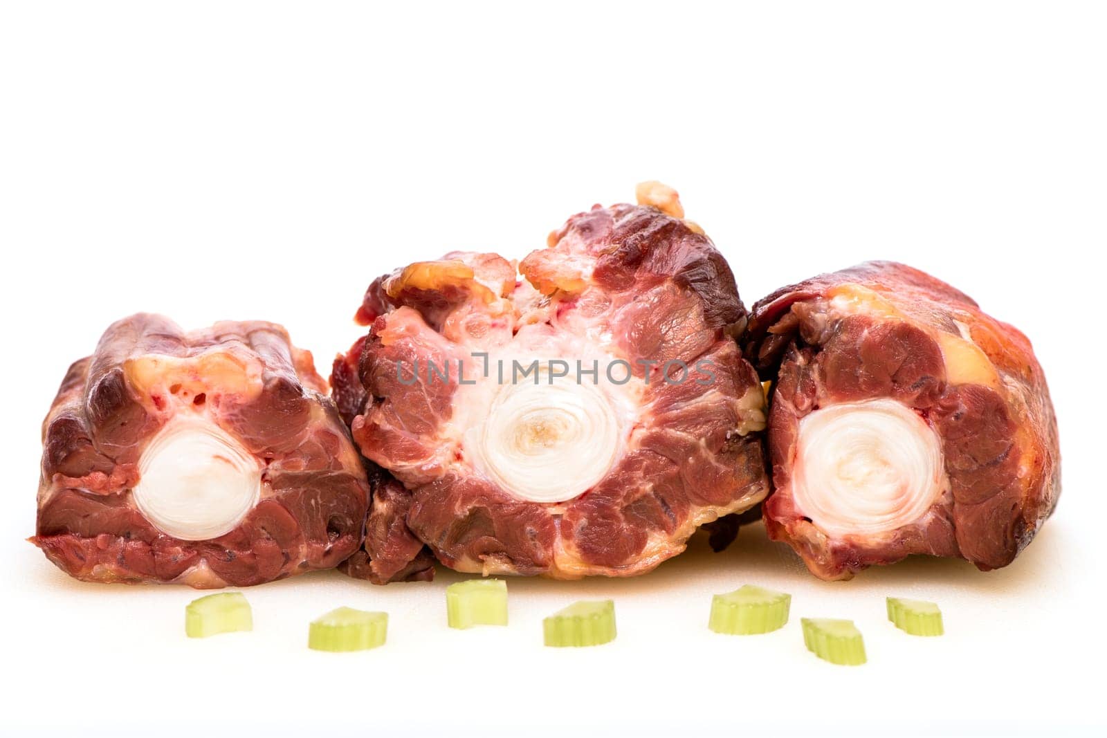 White insulated raw oxtail with celery