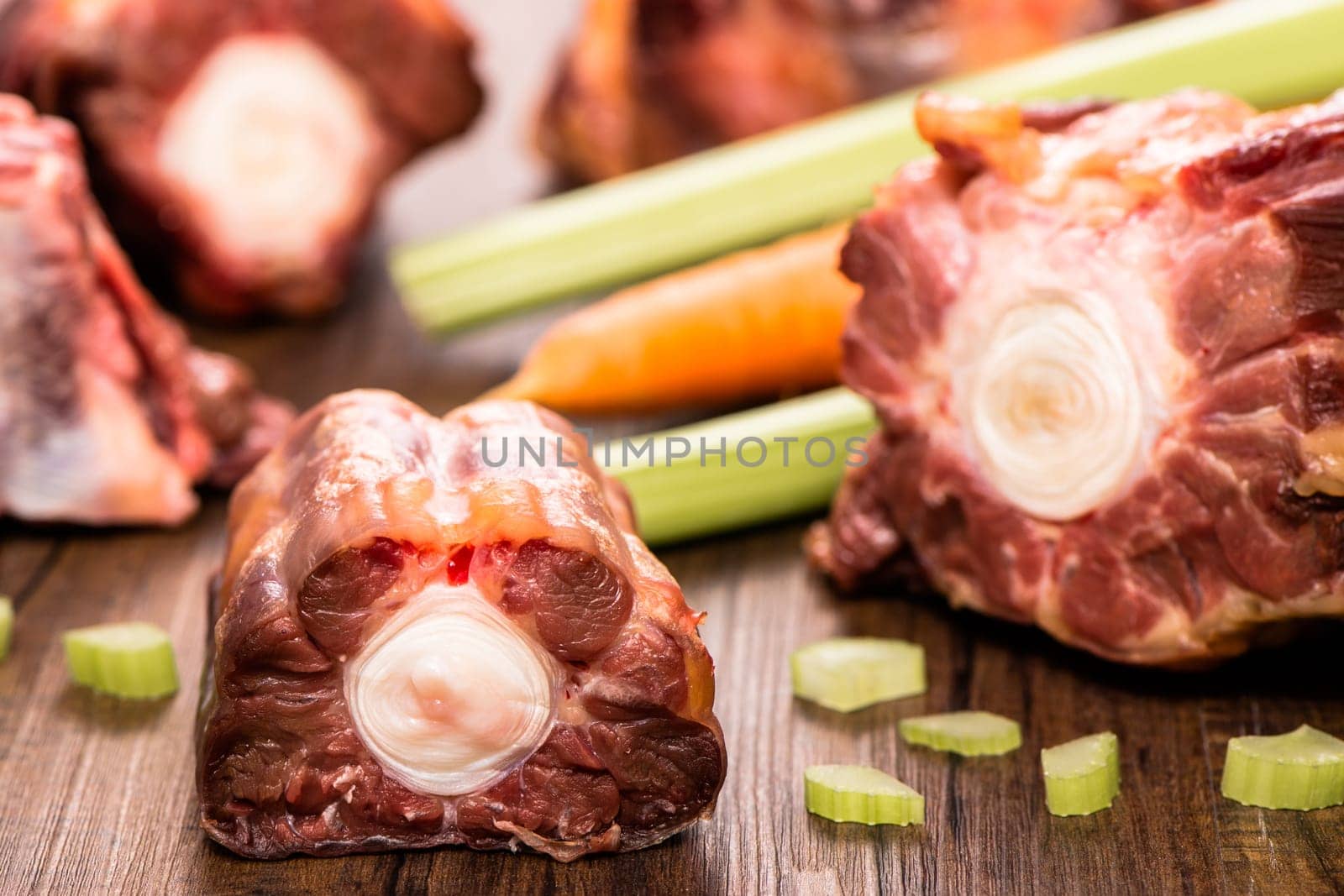 Raw piece of meat from oxtail with celery