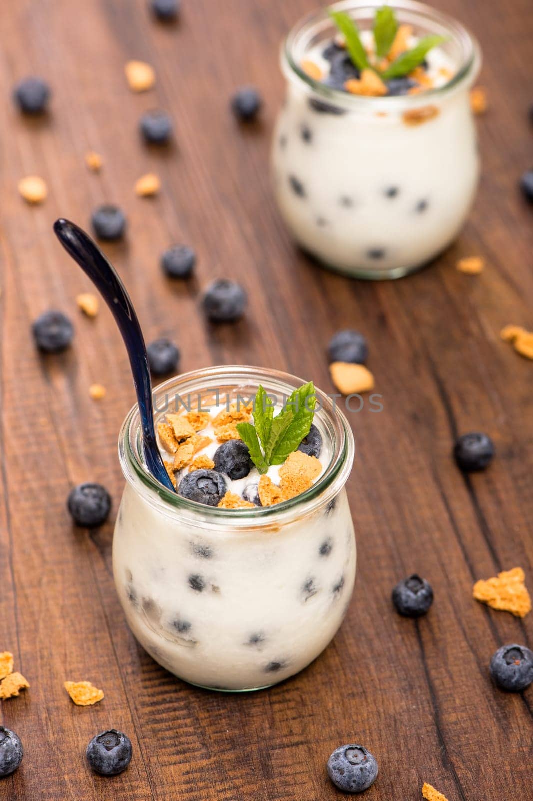 Yoghurt in glass with blueberries and cantuccini