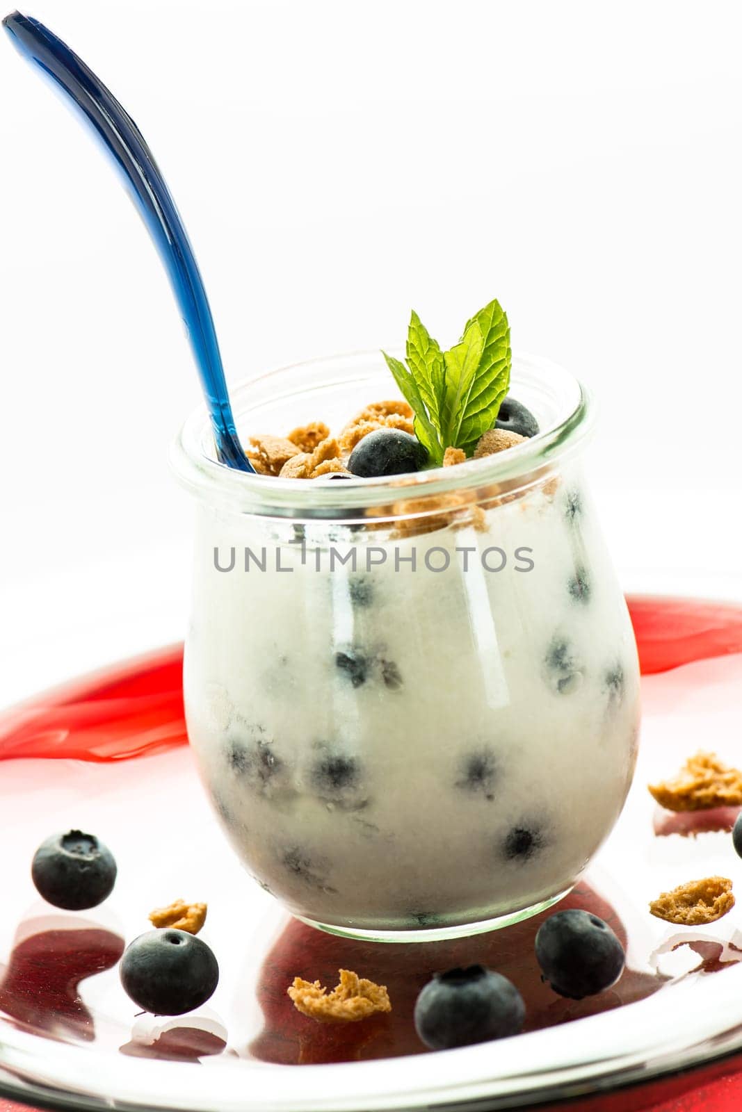 Yoghurt with heather berries,mint and cantucinni in a glass