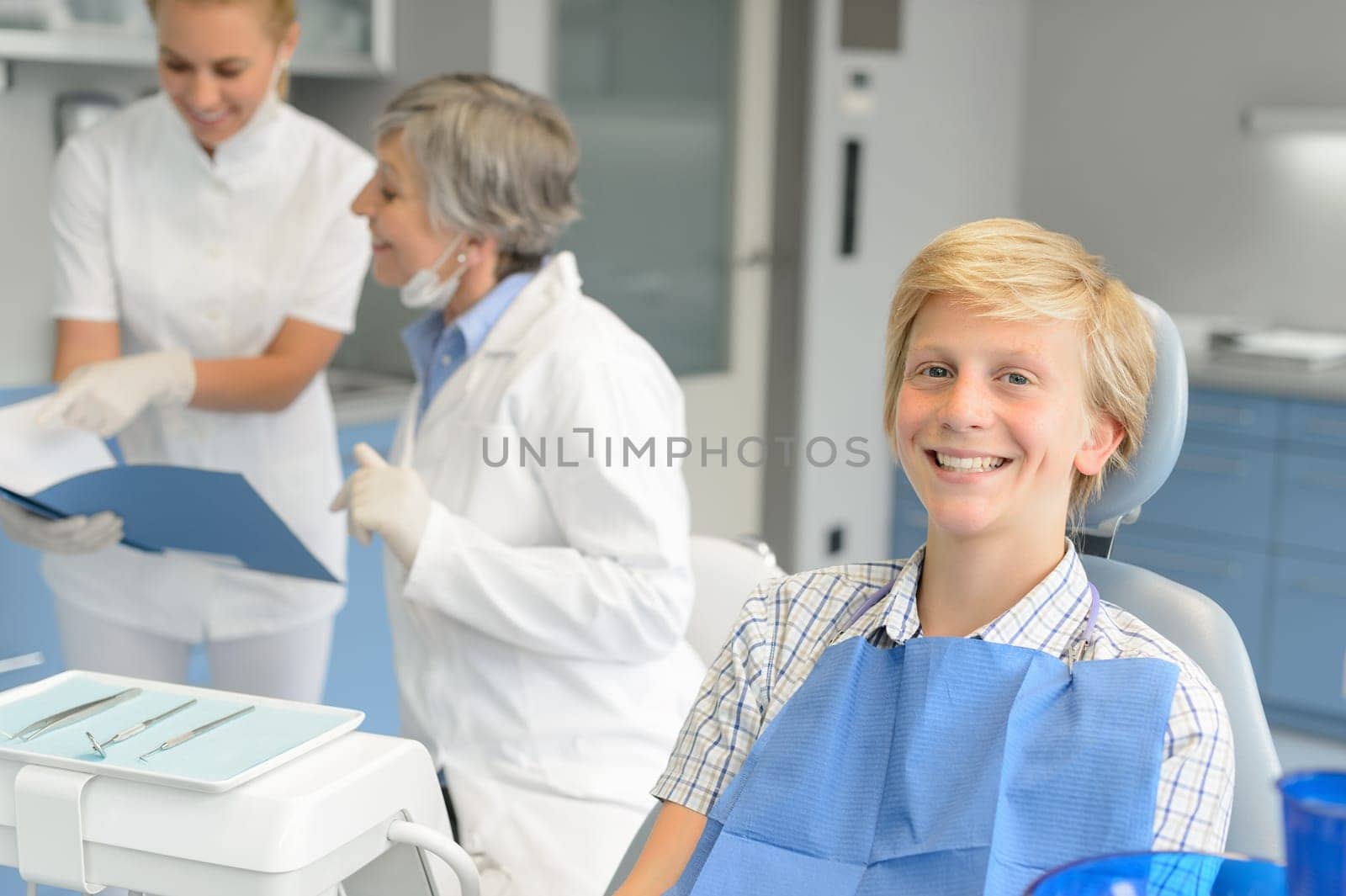 Dental checkup teenage patient boy and dentist nurse at stomatology clinic