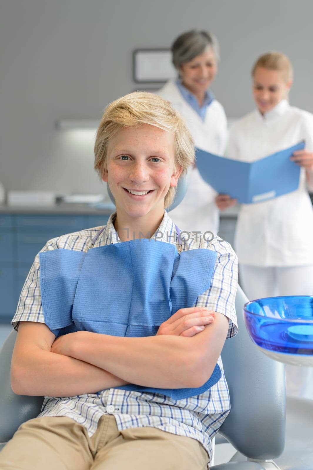 Teenager boy dental checkup dentist assistant standing at stomatology clinic
