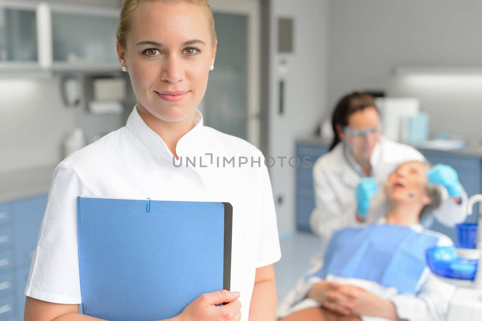 Dental assistant dentist checkup woman patient at stomatology clinic