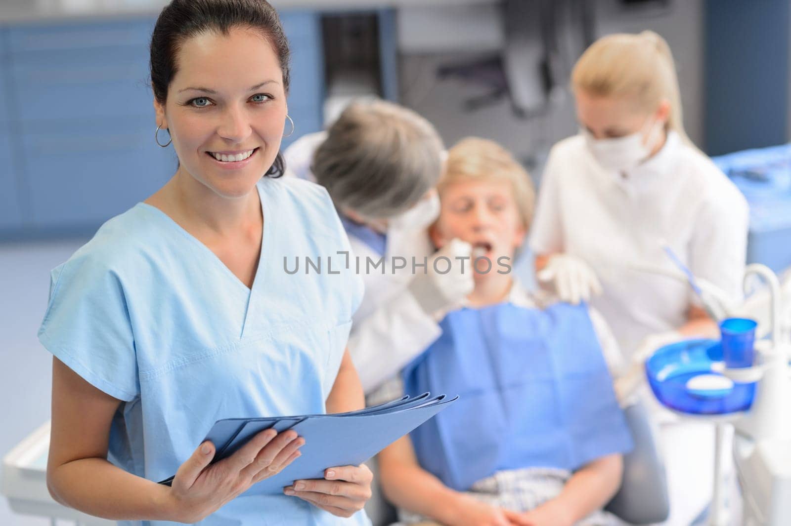 Professional dentist  team checkup teenage patient boy at dental surgery
