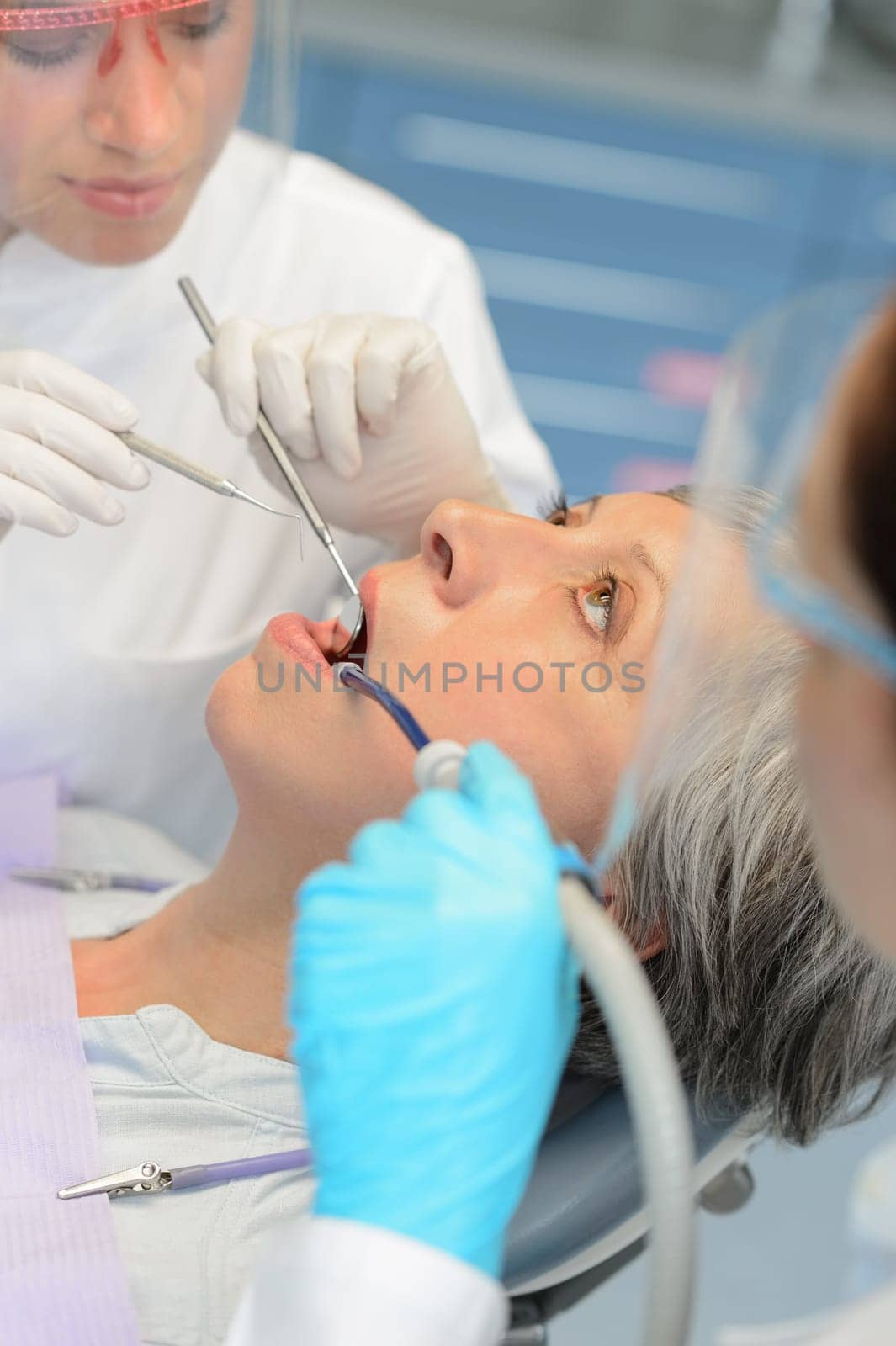 Professional dentists dental checkup senior patient woman open mouth