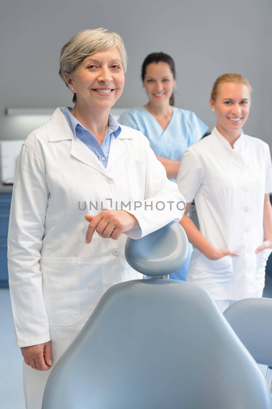 Professional dentist team three woman at dental surgery smiling portrait
