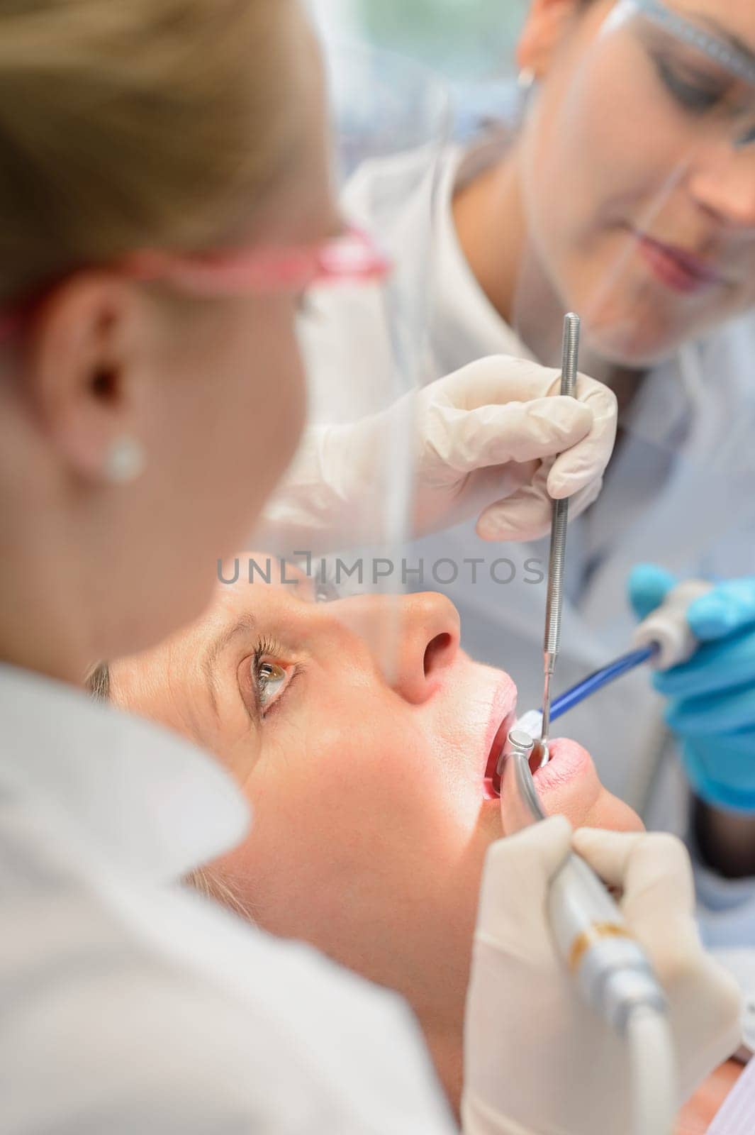 Professional dental team dentist checkup patient woman open mouth tools