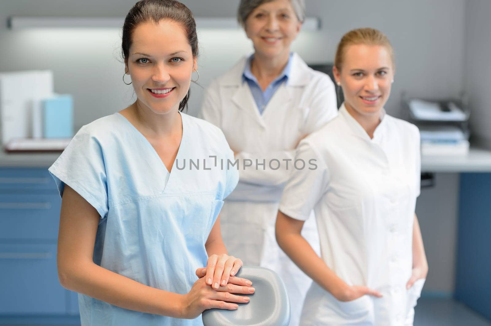 Three dentist woman team at dental surgery looking camera portrait