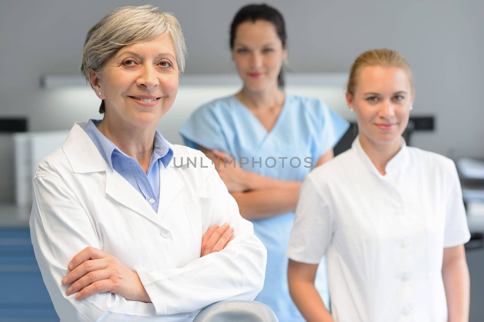 Medical team of three professional woman at dental surgery portrait