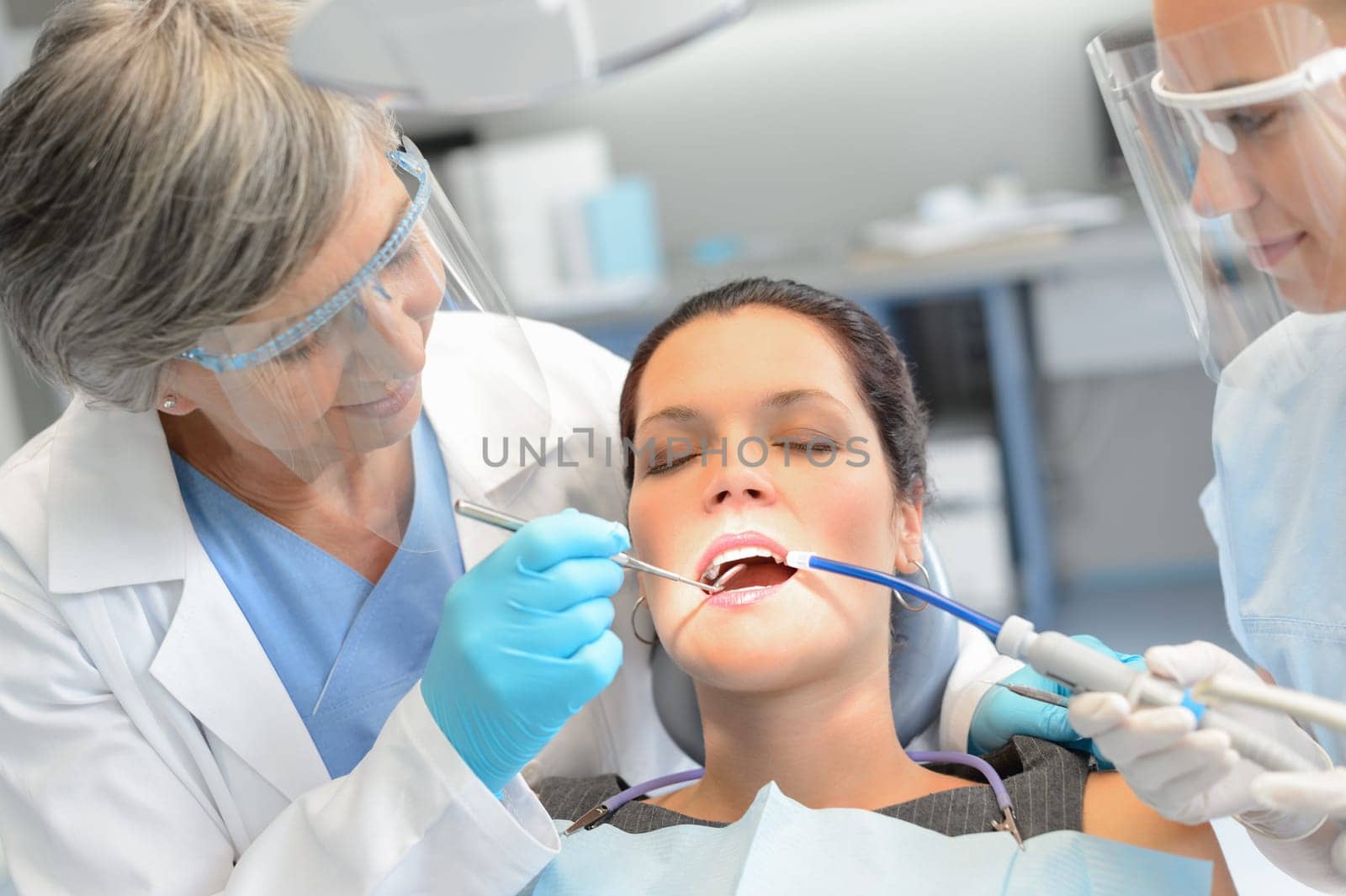 Dental check woman patient professional dentist team open mouth
