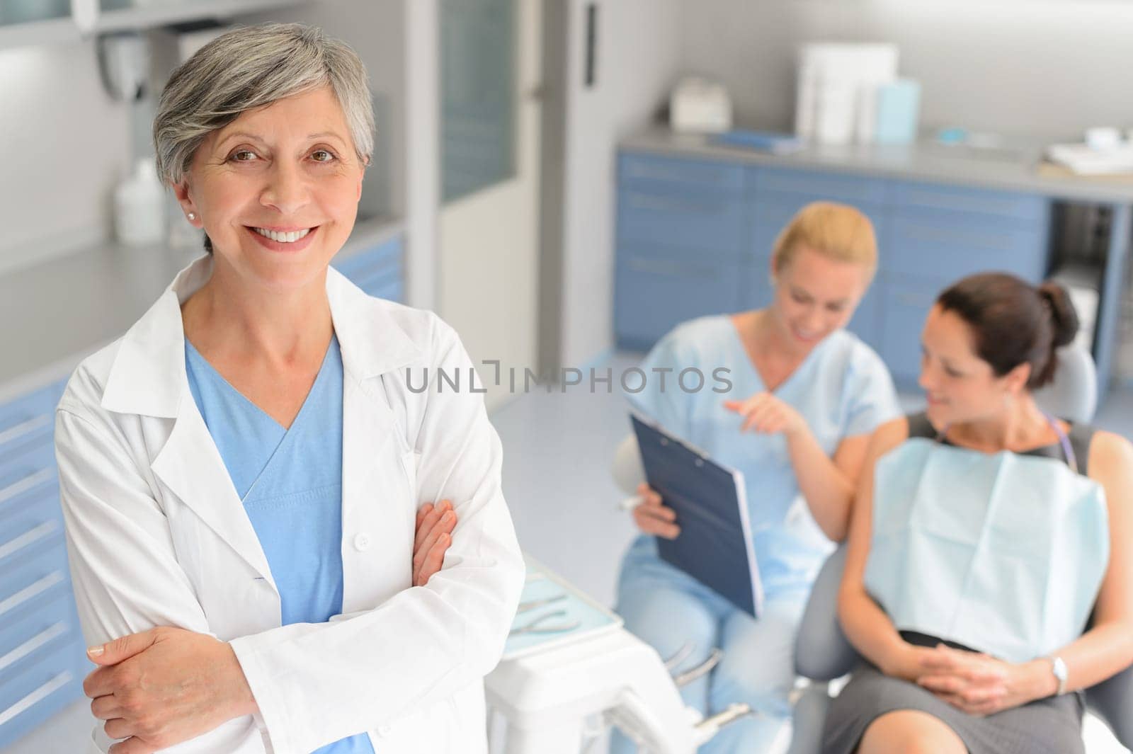 Professional dentist woman patient consultation with assistant at dental surgery