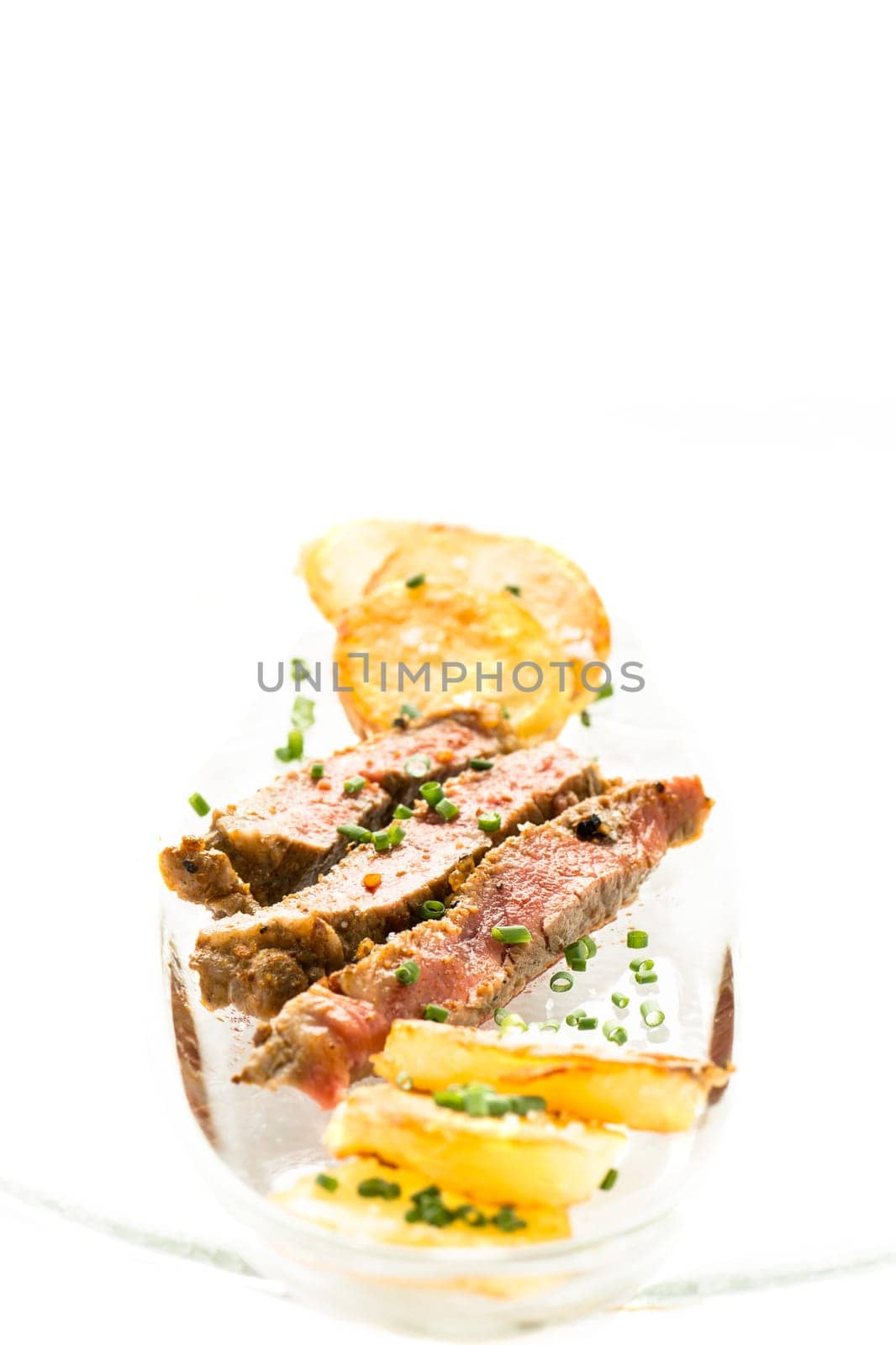 Entrecote and roast potatoes with chigs in portrait format