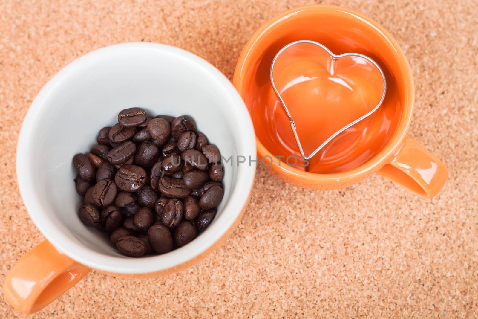 Cup of coffee bean and cookies cutter on cork background