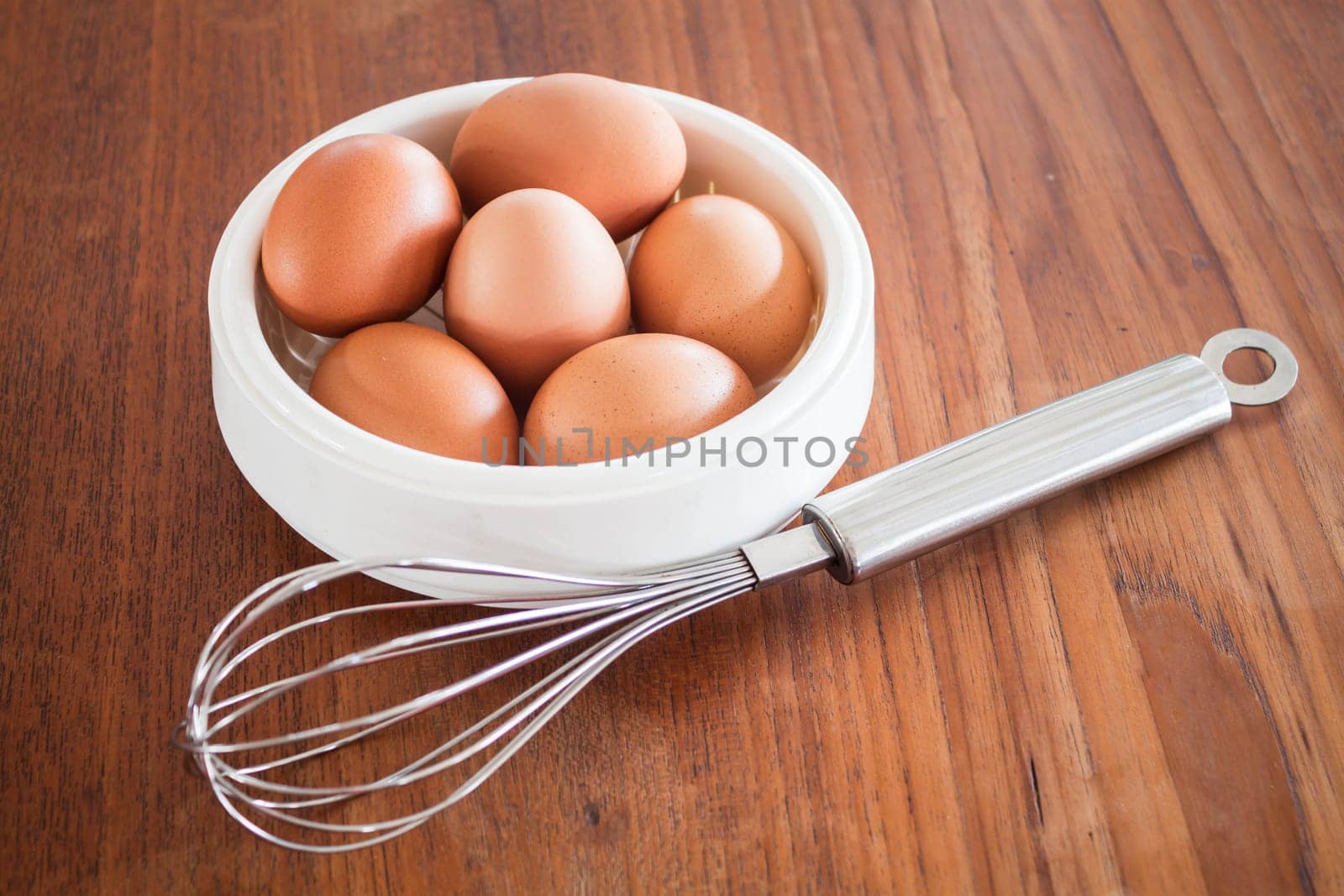 Fresh chicken eggs and hand mixer for beating