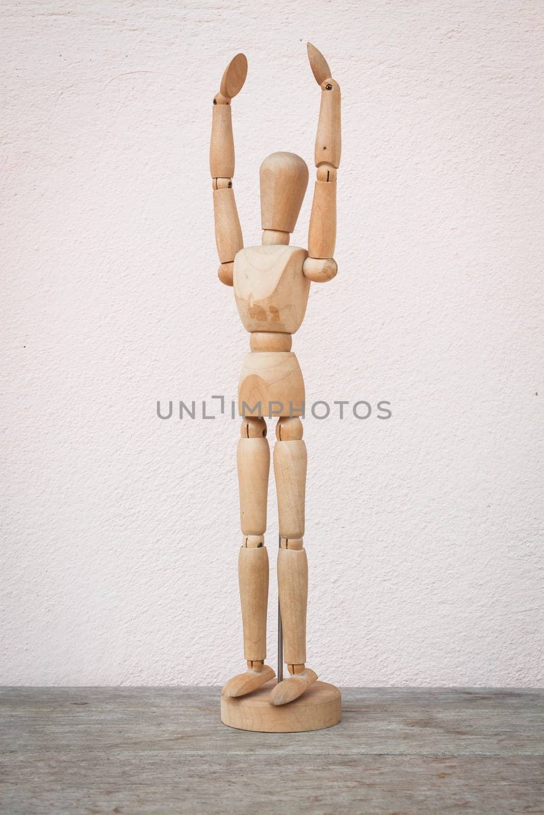 Raising hands up and standing wooden poser