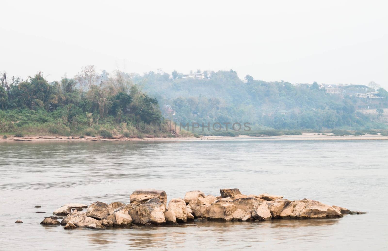 Peaceful scenic view of rocks middle the river