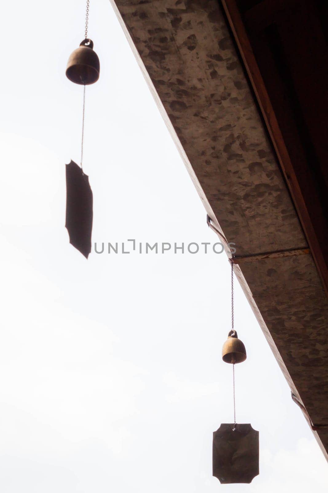 Small wind bell hang on eaves with white background