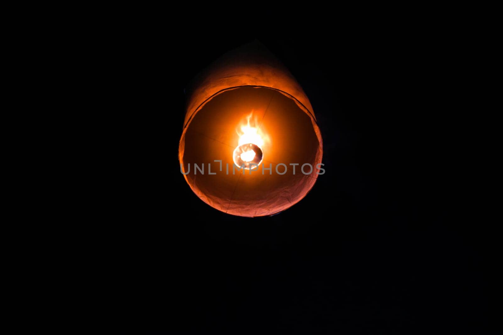 Single floating paper lantern during festival in Thailand
