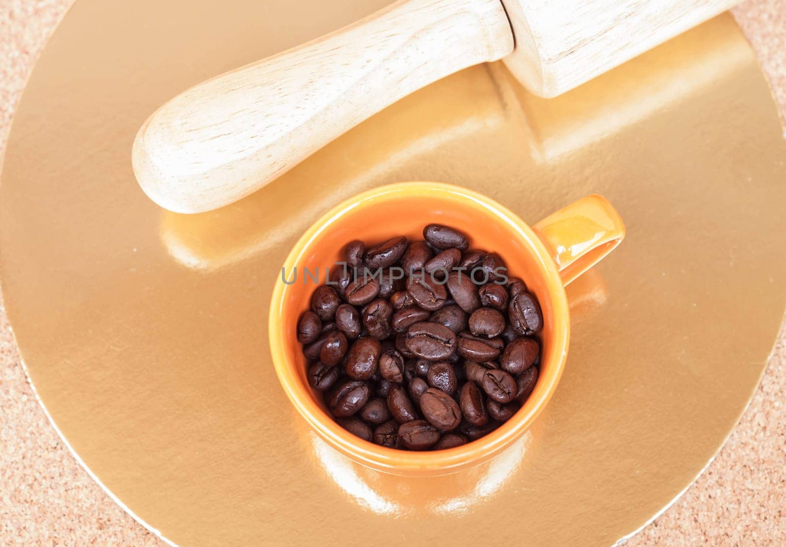 Roasted coffee beans in a cup on the table