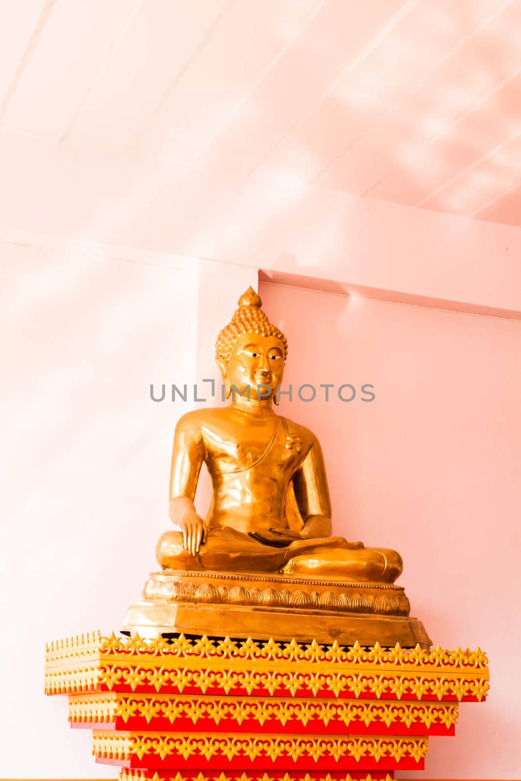 Sitting bronze buddha image statue inside of monk school room