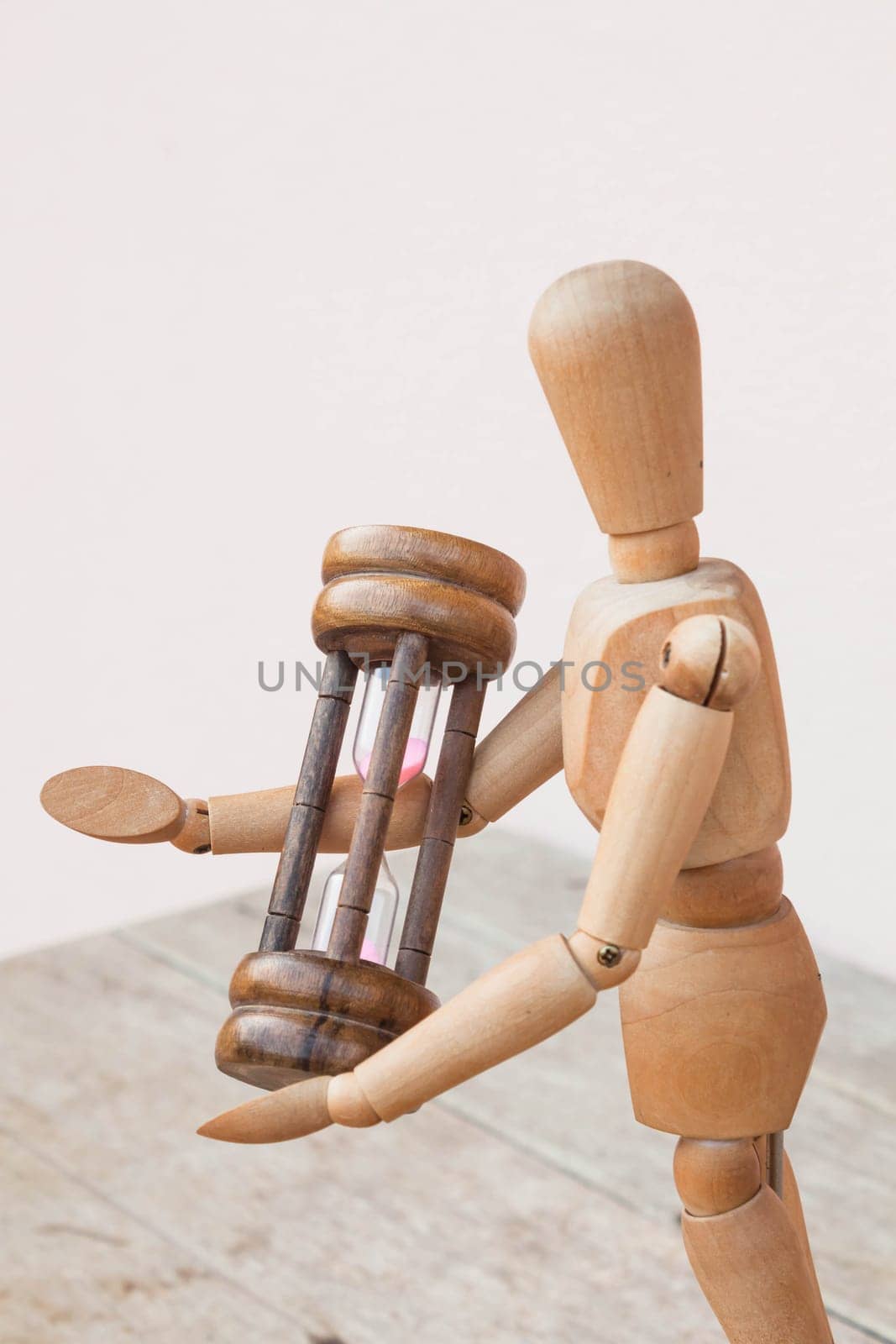 Wood mannequin and hourglass display time management