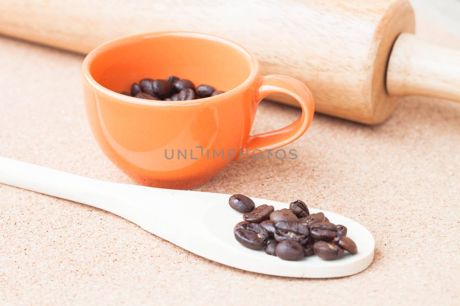 Roast coffee bean in a cup and wood spoon