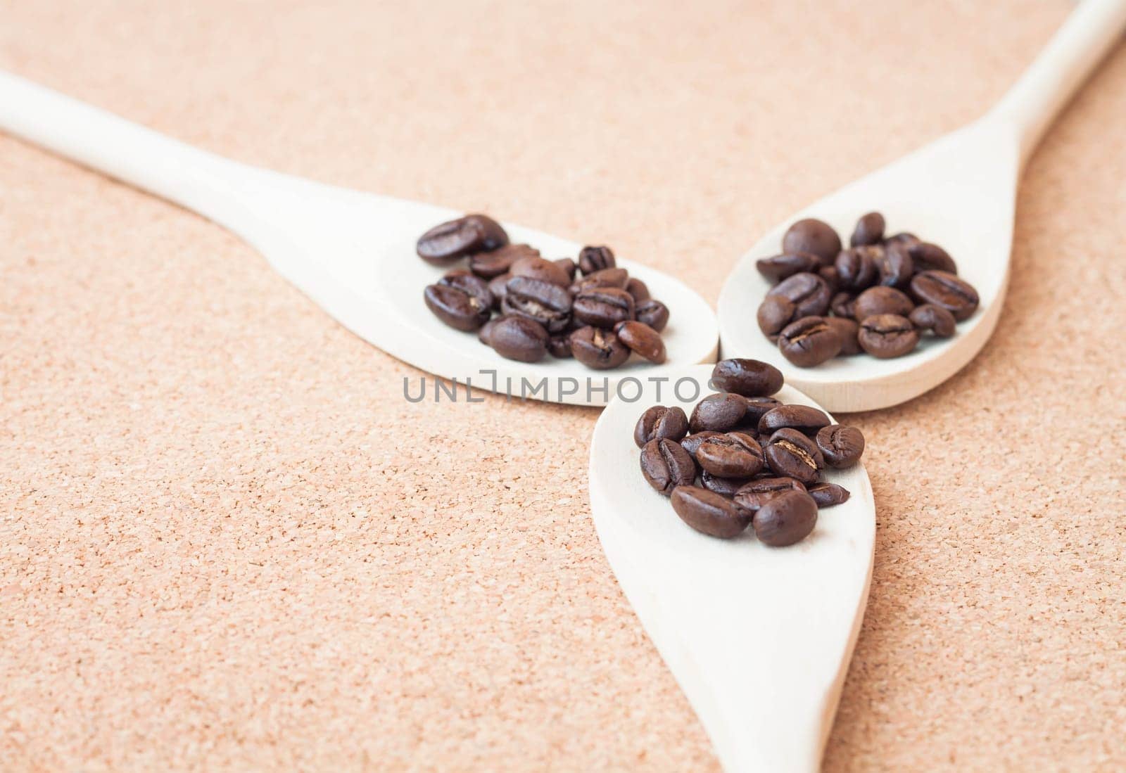 Roast coffee bean in wood spoons