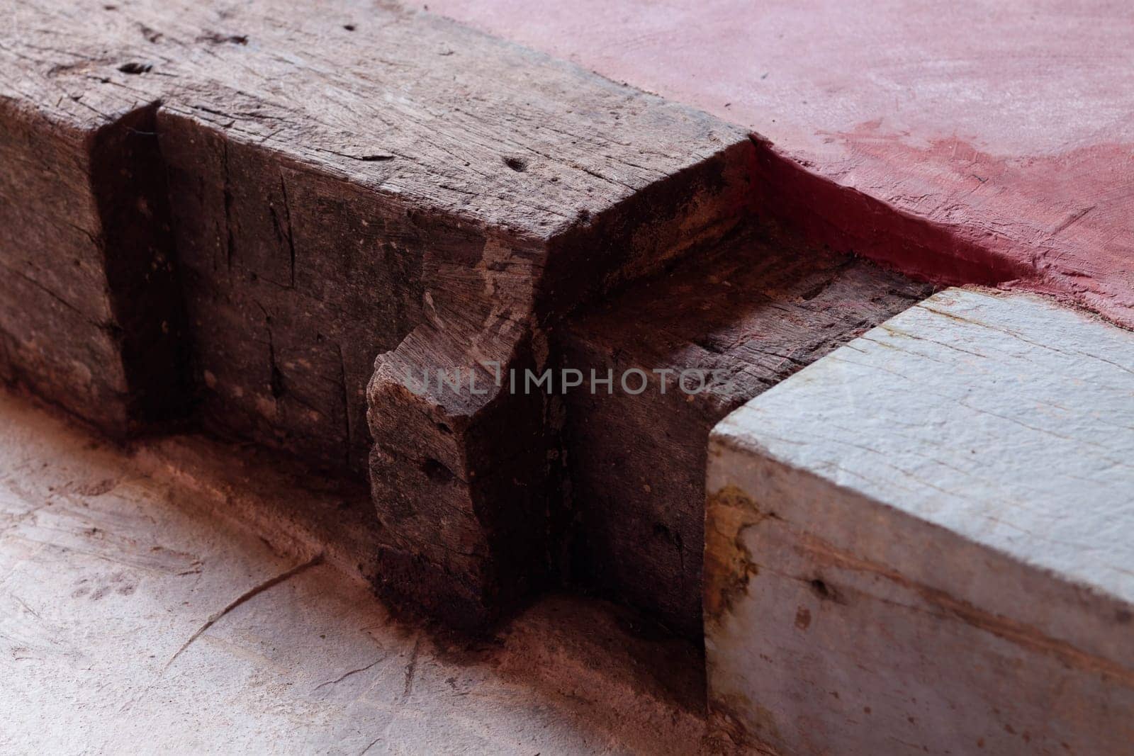 Wooden step on red concrete floor