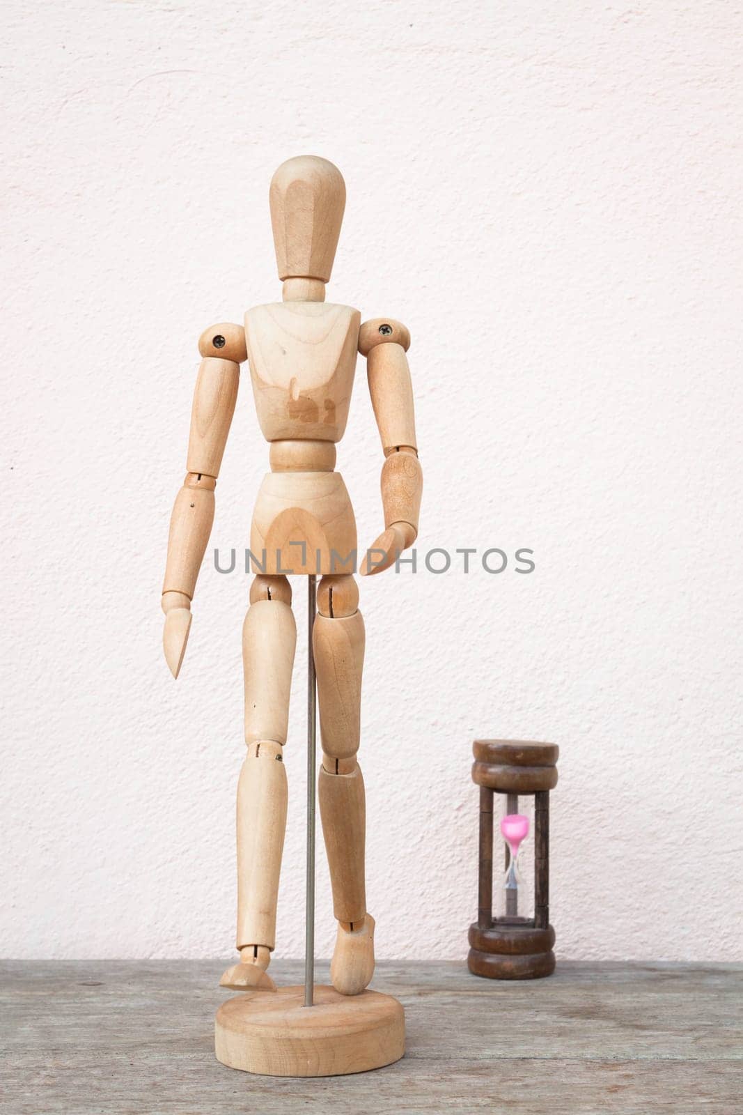 Wooden mannequin pose in concept of progress time