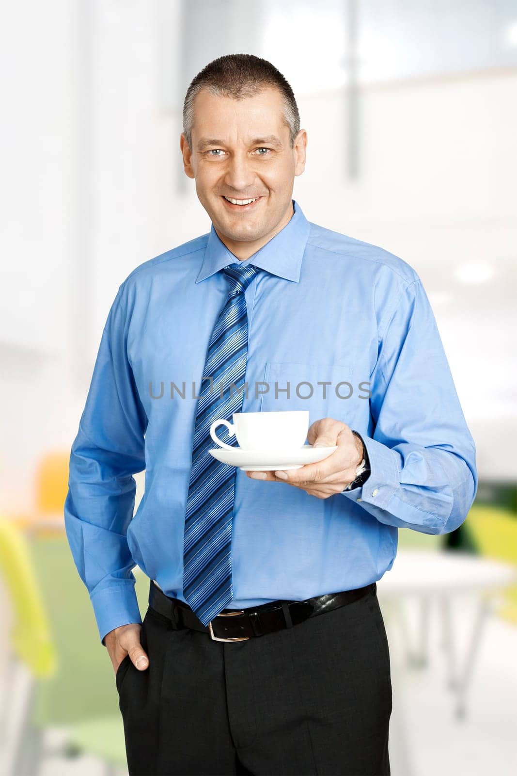 An image of a handsome business man with a cup of coffee
