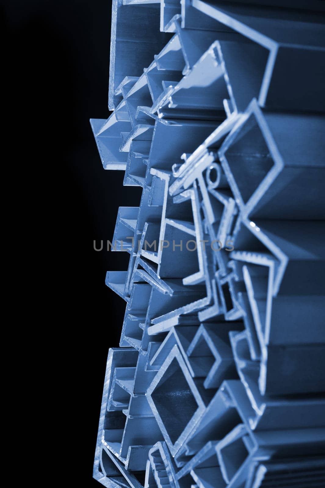many different aluminium profile strips in blue spotlight